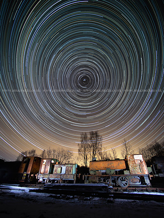 Star trails over old locomotives